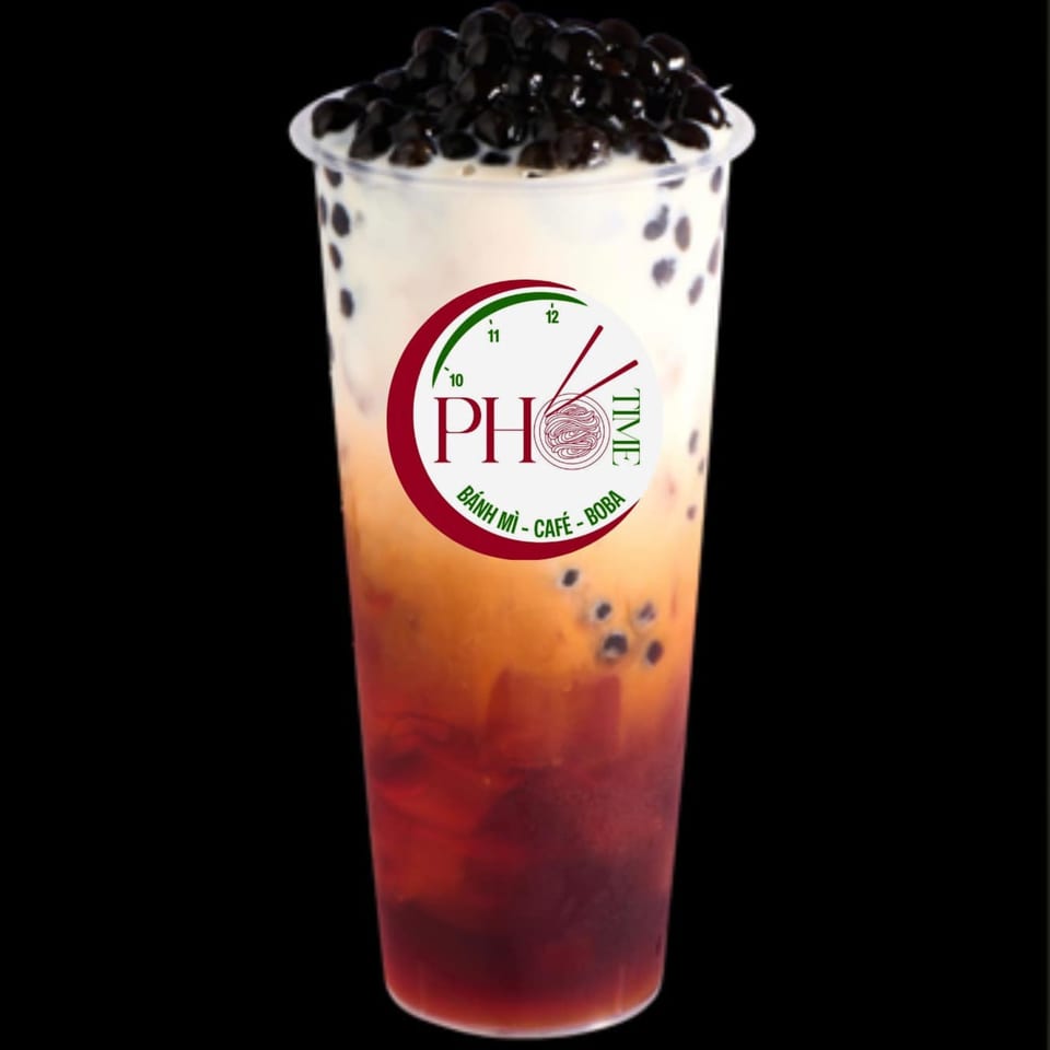 A Pho Time branded bubble tea with dark boba pearls, layered with red, orange, and white liquid.